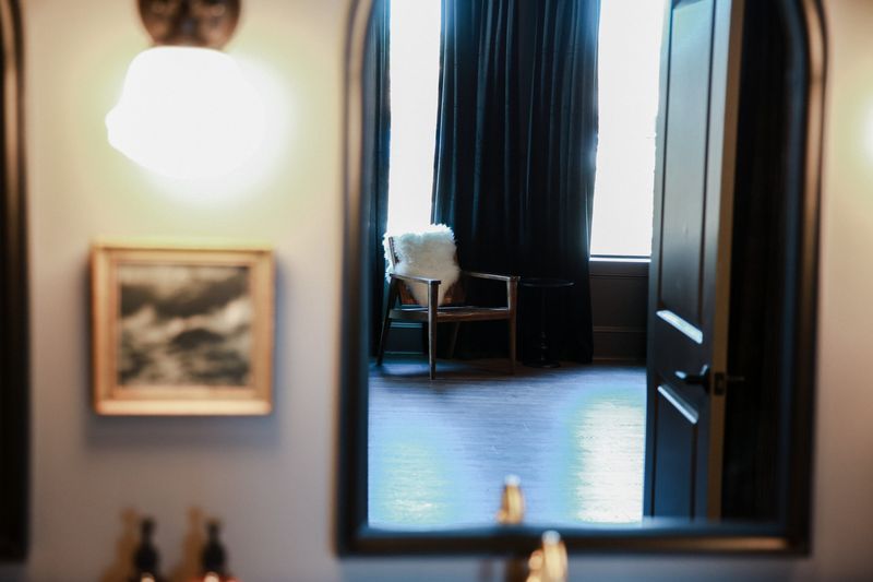 Suite hallway with a mirror and framed art